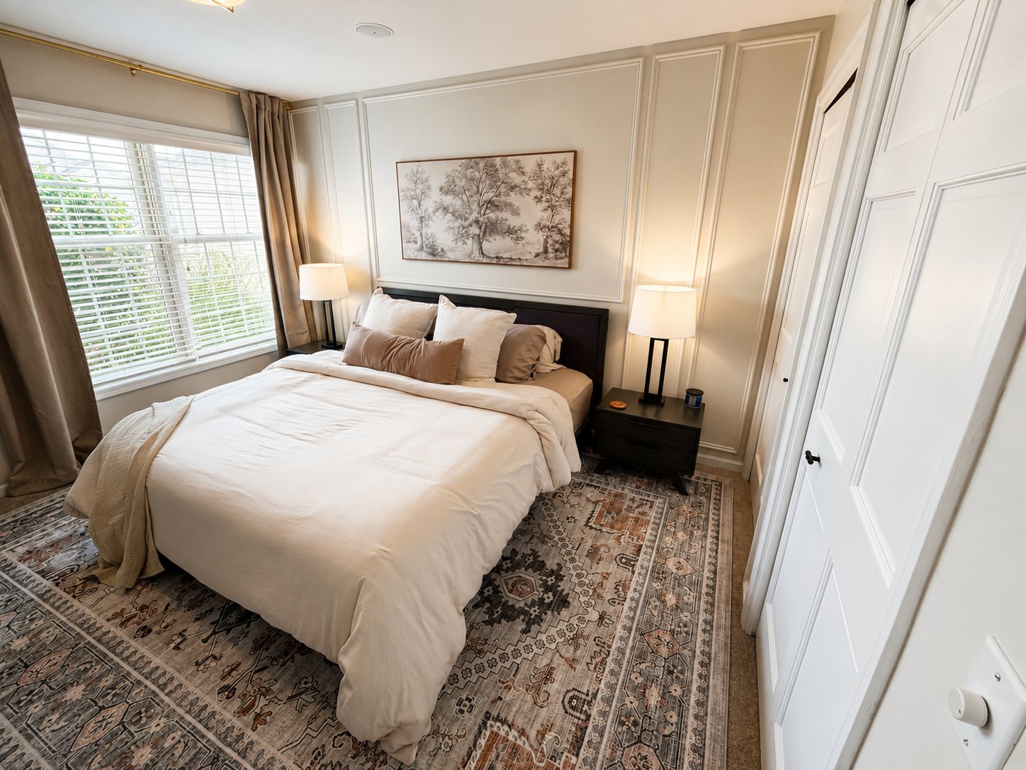 Box trim accent wall in a primary bedroom, styled with artwork and nightstands